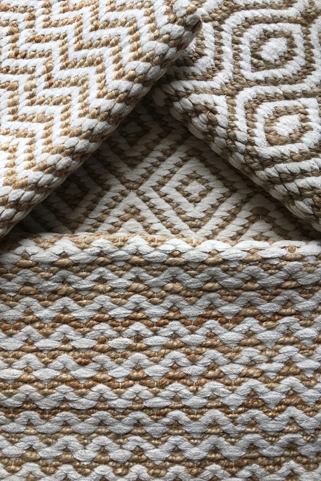 Folded handwoven rugs stacked to show their weave